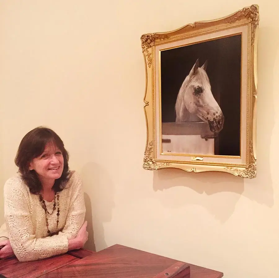 Framed pet portraits displayed in various sizes for customer guidance Pet portrait size guide showing framed artwork examples on a wall